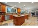 Open kitchen boasts granite countertops, stainless steel appliances, and large center island at 7086 Esperanza Dr, Castle Pines, CO 80108