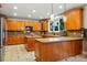 Spacious kitchen with custom wood cabinets, granite countertops, and an island at 7086 Esperanza Dr, Castle Pines, CO 80108