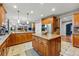 Spacious kitchen offers stainless appliances, granite counters, and large island, perfect for entertaining at 7086 Esperanza Dr, Castle Pines, CO 80108