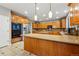 Gourmet kitchen with granite countertops, wooden cabinets, and modern stainless steel appliances at 7086 Esperanza Dr, Castle Pines, CO 80108