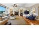 Cozy living room with a fireplace, built-in bookshelves, and hardwood flooring at 7086 Esperanza Dr, Castle Pines, CO 80108