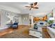 Open-concept living space with hardwood floors and seamless flow to the kitchen area at 7086 Esperanza Dr, Castle Pines, CO 80108
