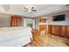 Another view of the spacious main bedroom featuring hardwood floors, access to an outdoor balcony, and an ensuite at 7086 Esperanza Dr, Castle Pines, CO 80108