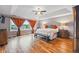 Spacious main bedroom with tray ceilings, hardwood floors, bright windows, and a sitting area, providing a relaxing retreat at 7086 Esperanza Dr, Castle Pines, CO 80108