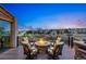 Cozy outdoor deck with a stone fire pit, comfortable seating, stone counter, and a panoramic neighborhood view at 7086 Esperanza Dr, Castle Pines, CO 80108