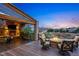 Relaxing outdoor deck area with a stone fireplace, TV, seating, and a fire pit with neighborhood views at 7086 Esperanza Dr, Castle Pines, CO 80108