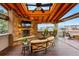 Outdoor patio with a stone fireplace, ceiling fan, skylights and neighborhood views at 7086 Esperanza Dr, Castle Pines, CO 80108