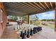 Under-cover patio with outdoor seating and a large chess board at 7086 Esperanza Dr, Castle Pines, CO 80108