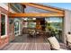 Stunning indoor outdoor patio with stone fireplace, outdoor kitchen, and expansive views at 7086 Esperanza Dr, Castle Pines, CO 80108