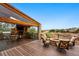 Outdoor patio with stone fire pit, covered seating and views of the neighborhood at 7086 Esperanza Dr, Castle Pines, CO 80108