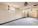Unfinished basement with paneled walls, a drop ceiling, two windows, and carpeting offers renovation potential at 5876 W Canyon Ave, Littleton, CO 80128