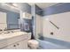 Bathroom with a tub and shower, vanity with storage, and a mirror at 5876 W Canyon Ave, Littleton, CO 80128