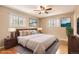 Comfortable bedroom with hardwood floors, two windows, and modern decor at 5876 W Canyon Ave, Littleton, CO 80128