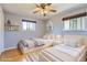 Charming bedroom featuring twin beds, hardwood floors and natural light at 5876 W Canyon Ave, Littleton, CO 80128