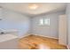 Bright bedroom features hardwood floors, natural light and a closet, offering a cozy and inviting space at 5876 W Canyon Ave, Littleton, CO 80128