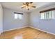 A nicely sized bedroom has wood floors, a ceiling fan and great natural light at 5876 W Canyon Ave, Littleton, CO 80128