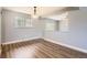 A spacious dining room has hardwood floors and fresh neutral paint at 5876 W Canyon Ave, Littleton, CO 80128