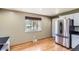 This kitchen features a modern stainless steel refrigerator and hardwood floors at 5876 W Canyon Ave, Littleton, CO 80128