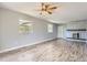 Spacious living room featuring a fireplace, hardwood floors, abundant natural light, and a ceiling fan at 5876 W Canyon Ave, Littleton, CO 80128