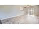 The spacious living room has hardwood floors and sliding glass doors at 5876 W Canyon Ave, Littleton, CO 80128