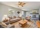A beautifully staged living room has a fireplace and neutral decor at 5876 W Canyon Ave, Littleton, CO 80128