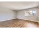 Bright living room features hardwood floors, neutral paint, and an open layout at 5876 W Canyon Ave, Littleton, CO 80128