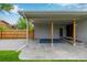The covered patio boasts wooden support beams and concrete flooring at 8231 E Lehigh Dr, Denver, CO 80237