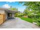 Charming backyard featuring a covered patio, lush lawn, and privacy fence at 8231 E Lehigh Dr, Denver, CO 80237