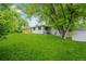 The spacious backyard includes green grass and mature trees at 8231 E Lehigh Dr, Denver, CO 80237