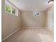 Finished basement room with carpet, windows, neutral paint, and closet space at 8231 E Lehigh Dr, Denver, CO 80237