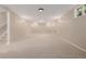 Spacious basement with neutral carpet, updated lighting, and plenty of room for activities at 8231 E Lehigh Dr, Denver, CO 80237