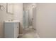 Well-lit bathroom features a modern vanity, updated light fixtures, and a shower at 8231 E Lehigh Dr, Denver, CO 80237