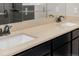 Bathroom featuring a double vanity with sleek faucets and a large mirror at 8231 E Lehigh Dr, Denver, CO 80237