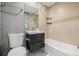 Bathroom featuring a modern vanity, tile walls, and a combination tub and shower at 8231 E Lehigh Dr, Denver, CO 80237