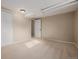 Cozy bedroom with neutral carpet, updated lighting, and easy access to the closet and hallway at 8231 E Lehigh Dr, Denver, CO 80237