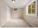Carpeted bedroom with natural light from the window and a closet for storage at 8231 E Lehigh Dr, Denver, CO 80237