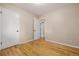 Bright bedroom featuring hardwood floors, neutral walls, and white doors and trim at 8231 E Lehigh Dr, Denver, CO 80237