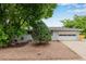 Single-story home with well-manicured front yard, gray paint, mature trees, and two car garage at 8231 E Lehigh Dr, Denver, CO 80237