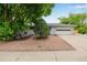 Single-story home with well-manicured front yard, gray paint, mature trees, and two car garage at 8231 E Lehigh Dr, Denver, CO 80237