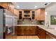This kitchen features wood cabinets, stainless steel appliances, and sleek countertops at 8231 E Lehigh Dr, Denver, CO 80237