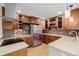 This kitchen features wood cabinets, stainless steel appliances, and sleek countertops at 8231 E Lehigh Dr, Denver, CO 80237