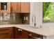 This kitchen features light countertops, wood cabinets and stainless steel appliances at 8231 E Lehigh Dr, Denver, CO 80237
