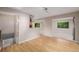Bright living room with hardwood floors and natural light, open to other living spaces and kitchen at 8231 E Lehigh Dr, Denver, CO 80237