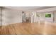 Open-concept living space with hardwood floors and a modern staircase at 8231 E Lehigh Dr, Denver, CO 80237