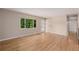 Sunlit living room with hardwood floors and a large window view at 8231 E Lehigh Dr, Denver, CO 80237