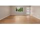 Bright room with hardwood floors and a view of lush greenery at 8231 E Lehigh Dr, Denver, CO 80237