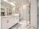 Bathroom with double vanity and large glass shower with bench seating at 9012 Borrowdale Ln, Parker, CO 80134