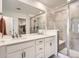 Modern bathroom features double vanity, quartz countertops, and a large tiled walk-in shower at 9012 Borrowdale Ln, Parker, CO 80134
