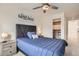 Comfortable bedroom with a ceiling fan, stylish decor, and a walk-in closet at 9012 Borrowdale Ln, Parker, CO 80134