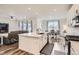 Open-concept kitchen flows to living and dining areas, featuring a large island and stainless steel appliances at 9012 Borrowdale Ln, Parker, CO 80134